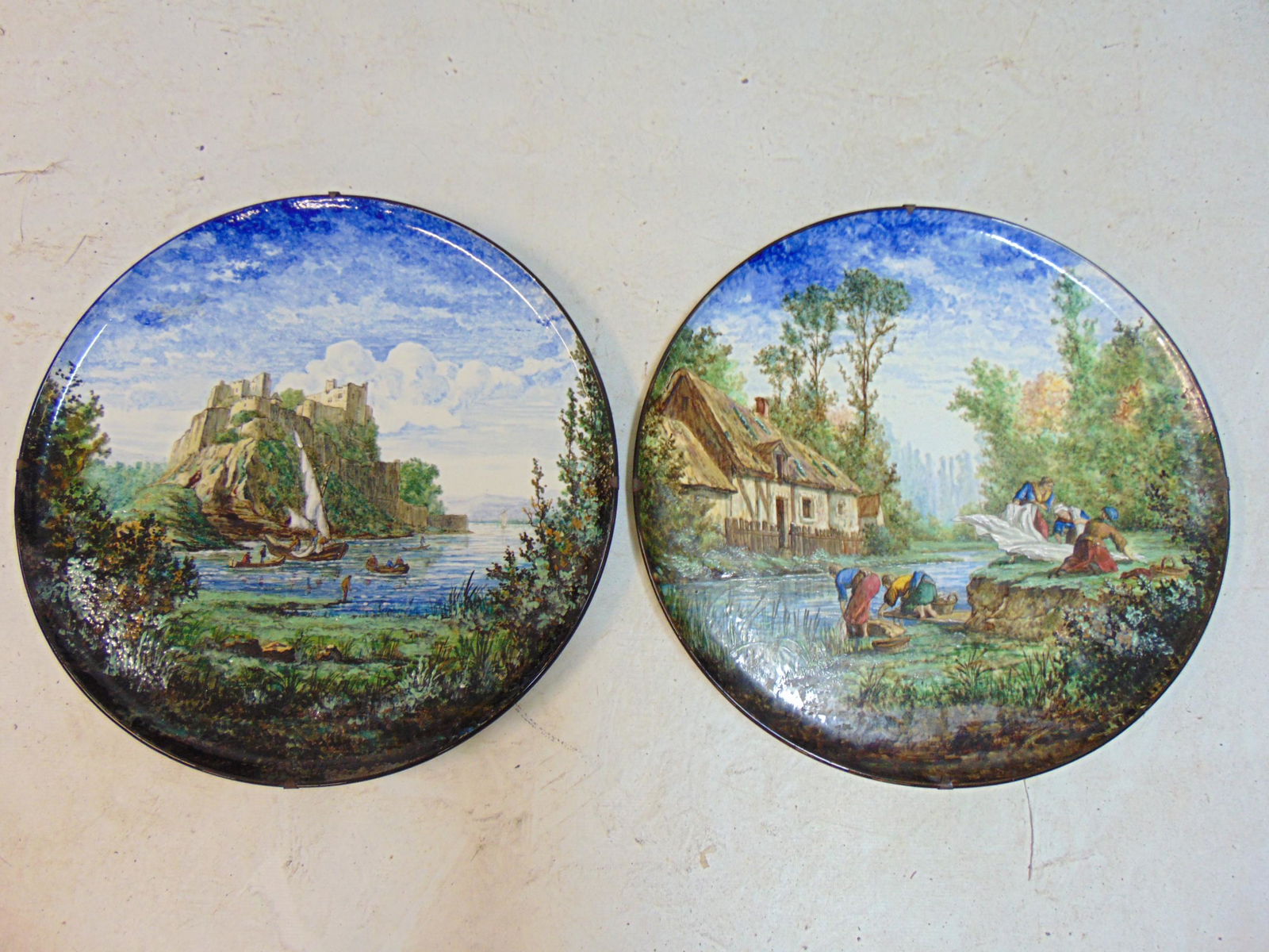 Pair large Gien Marois chargers, French earthenware, ceramic glazed and enameled landscapes, each: Pair large Gien Marois chargers, French earthenware, ceramic glazed and enameled landscapes, each charger, plate is 17 5/8" one is artist signed, includes scene of figures washing clothes in a stream