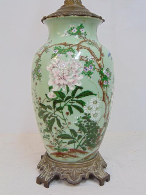 Chinese porcelain table lamp, floral, blossom decorated, on green, celadon body, lamp comes with: Chinese porcelain table lamp, floral, blossom decorated, on green, celadon body, lamp comes with fancy linen oversized (not original) shade & jade finial with happiness symbol, height is 31"