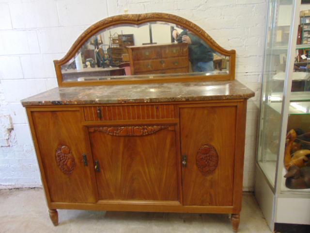 Marble top art deco sideboard with mirrored backsplash, carved detail, with keys, one pull on drawer: Marble top art deco sideboard with mirrored backsplash, carved detail, with keys, one pull on drawer is missing, cabinet is 59" by 21", height base to marble is 40.25", height to top mirror is 61.5"