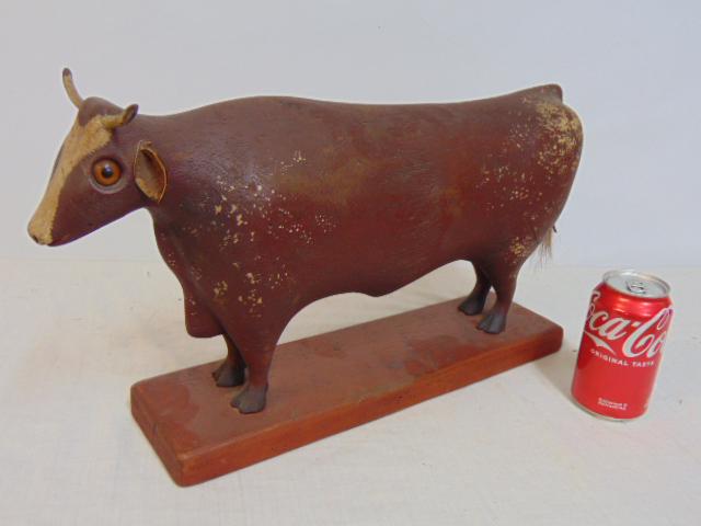 Folk art carved cow, William Jauquet, carved & painted wood cow with leather ears, rope tail & glass: Folk art carved cow, William Jauquet, carved & painted wood cow with leather ears, rope tail & glass eyes, base is 16 3/8" by 4.25", height is 11"