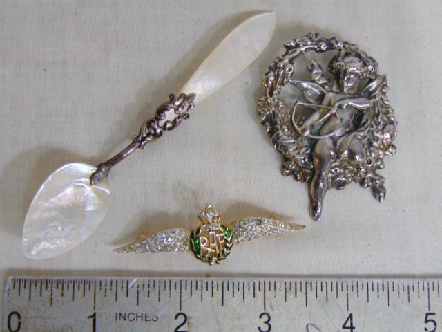 Mother of pearl spoon, R.A.F. Trifari brooch & putti pin: Mother of pearl spoon, R.A.F. Trifari brooch & putti pin