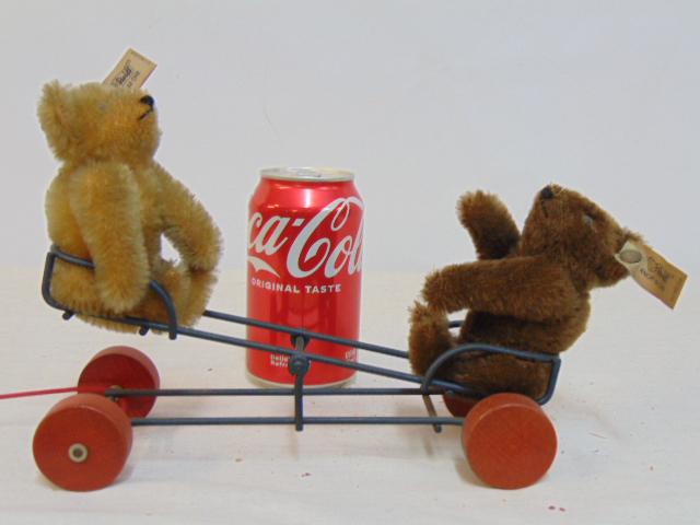 2 Steiff bears on a seesaw, 0132/24 bears, brown & beige on a iron seesaw with wood wheels: 2 Steiff bears on a seesaw, 0132/24 bears, brown & beige on a iron seesaw with wood wheels
