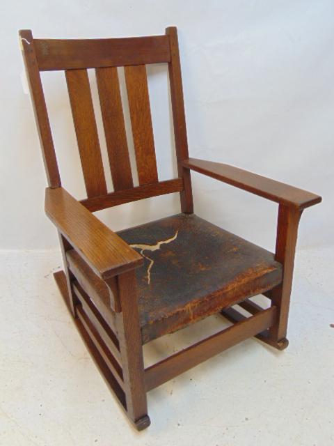 Gustav Stickley rocker, oak arts & crafts, leather seat (ripped), chair is 26" wide, 22" deep: Gustav Stickley rocker, oak arts & crafts, leather seat (ripped), chair is 26" wide, 22" deep (arms), height is 38"