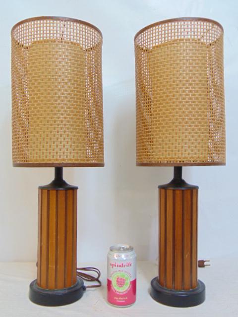 Pair Mid Century table lamps, composite "wood" bases with woven caned shades.: Pair Mid Century table lamps, composite bases made to look like wood with woven caned shades with inner diffuser tube, lamps are 24" tall, shades in good condition, no damage.