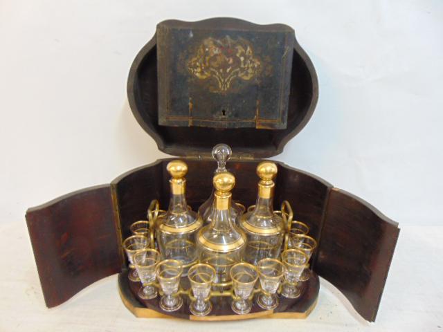 19th Century tantalus bar in inlaid case, case as is, piece of front molding missing, set contains 4: 19th Century tantalus bar in inlaid case, case as is, piece of front molding missing, set contains 4 decanters (three match, one is not original) and 15 gold rimmed glasses, one glass missing, dated 1