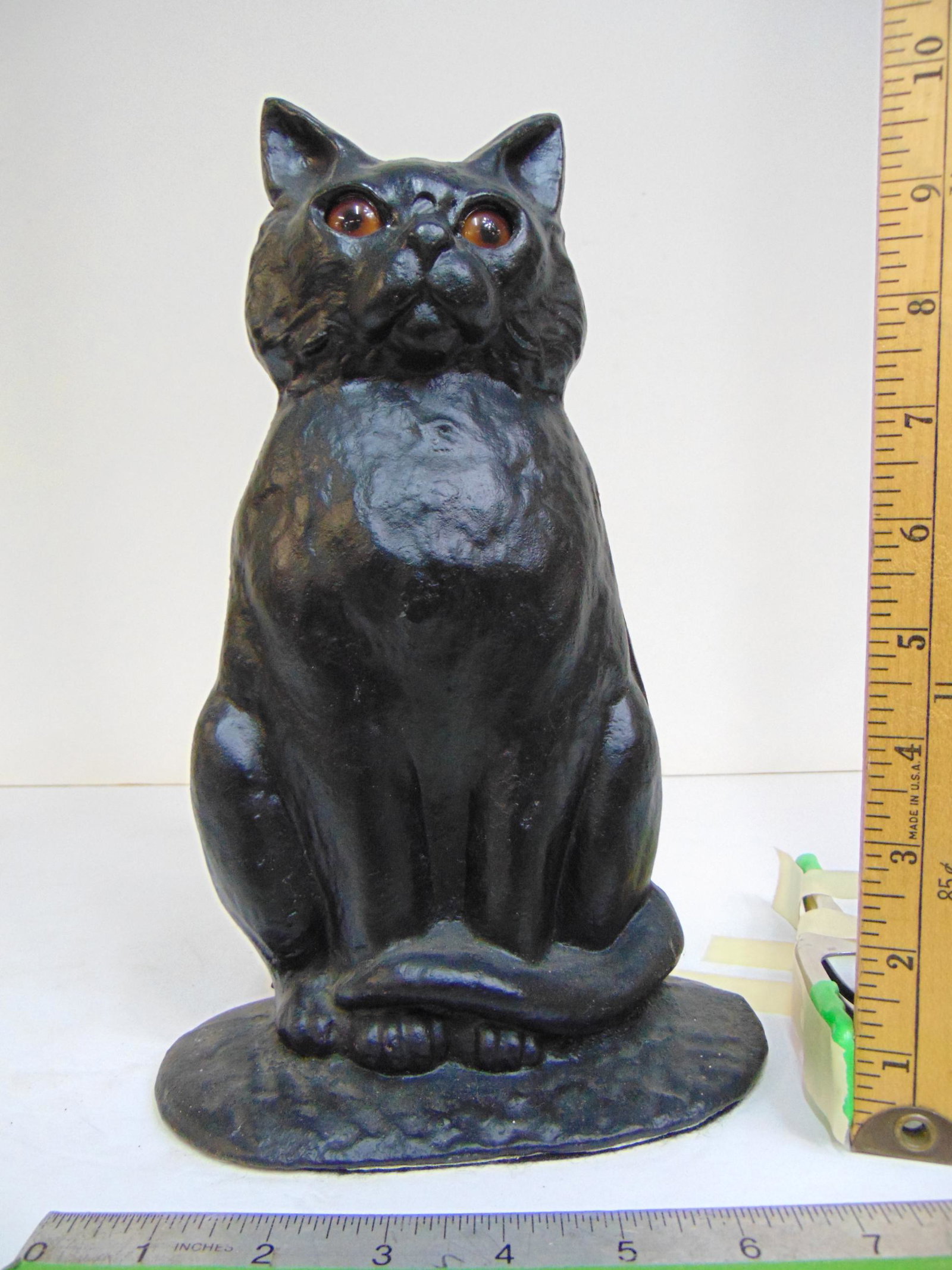Cast iron cat doorstop with glass eyes, 7" wide, height is 11 1/8": Cast iron cat doorstop with glass eyes, 7" wide, height is 11 1/8"