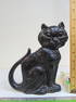 Cast iron doorstop, cat in black paint, signed on back, illegible, copyright 1927, height is 7 7/8"