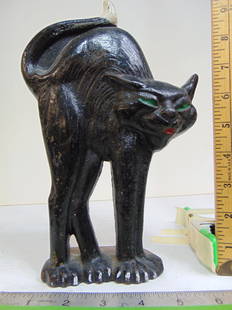 Cast iron Cat doorstop, arched back black cat, green eyes & white tipped tail, number 973 on back,: Cast iron Cat doorstop, arched back black cat, green eyes & white tipped tail, number 973 on back, height is 9 7/8"