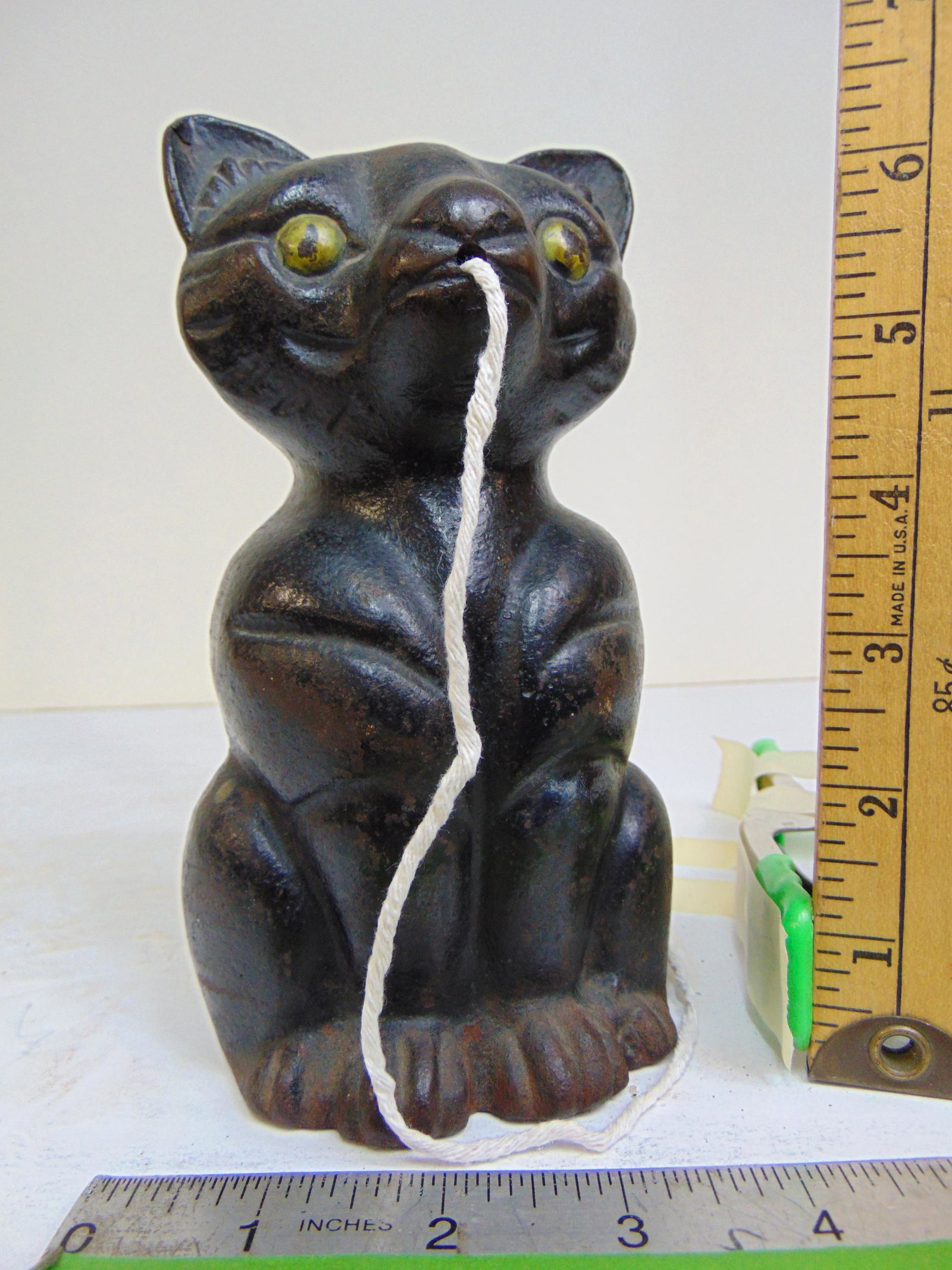 Cast iron cat string dispenser, in black with yellow eyes. (1 of 5)