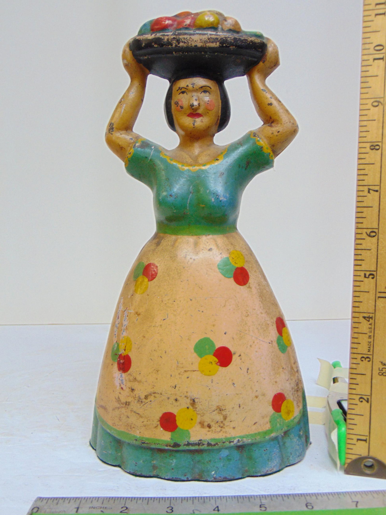 Cast iron doorstop, lady carrying basket of fruit, height is 11.5", faint marks bottom (1 of 4)