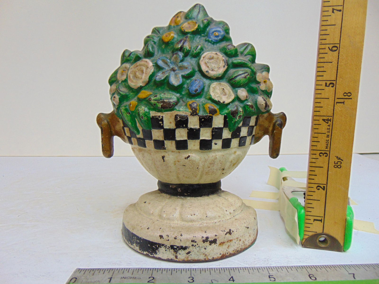 Cast iron flower basket doorstop, in urn with checkerboard border, height is 7 5/8": Cast iron flower basket doorstop, in urn with checkerboard border, height is 7 5/8"