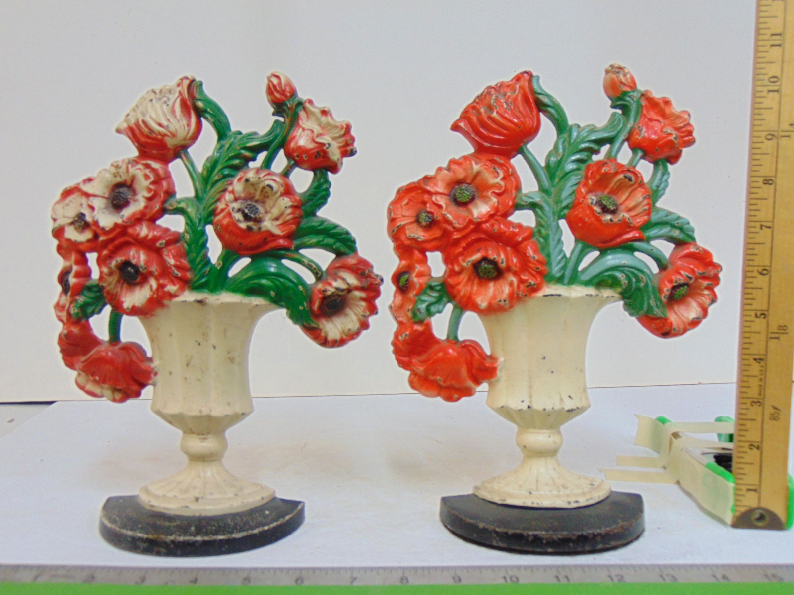 Pair matching Hubley cast iron floral doorstops, Poppies, marked #440, red & white flowers in white: Pair matching Hubley cast iron floral doorstops, Poppies, marked #440, red & white flowers in white urn vase, height is 10.5"