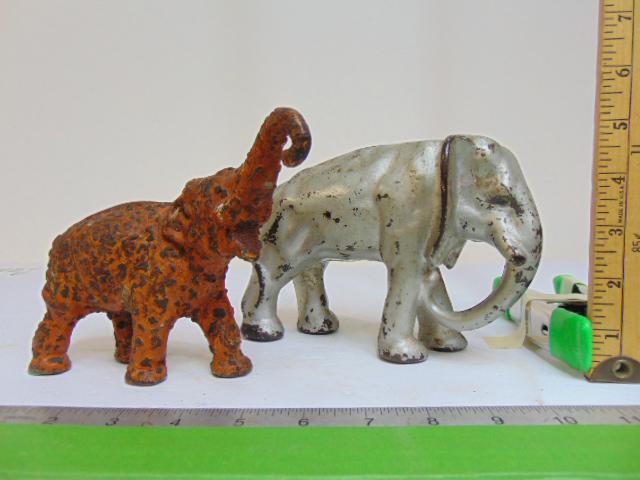 2 cast iron elephant doorstops, on in silver paint, other in distressed orange paint, 4 7/8" & 5" (1 of 5)