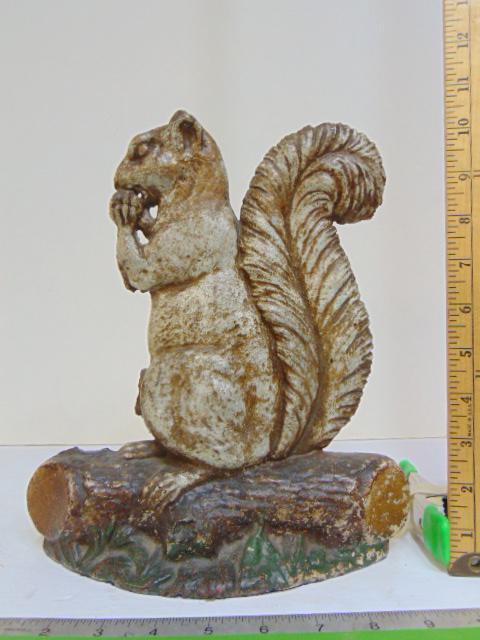 Cast iron squirrel doorstop, missing small piece of leg, squirrel on log, 11 1/8" tall. (1 of 4)