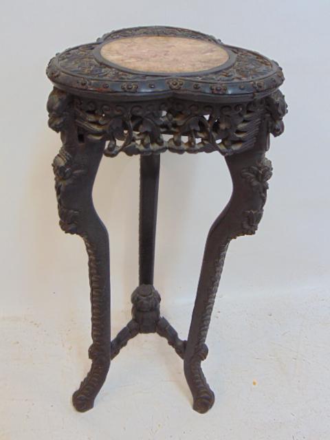 Chinese marble top plant stand, carved wood base, stand is 30.75" tall, carved heads, one side of: Chinese marble top plant stand, carved wood base, stand is 30.75" tall, carved heads, one side of skirt as is, loss.