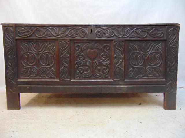 Early oak coffer or book chest, extensive carved front with flowers, tulips, pineapple in center, (1 of 7)