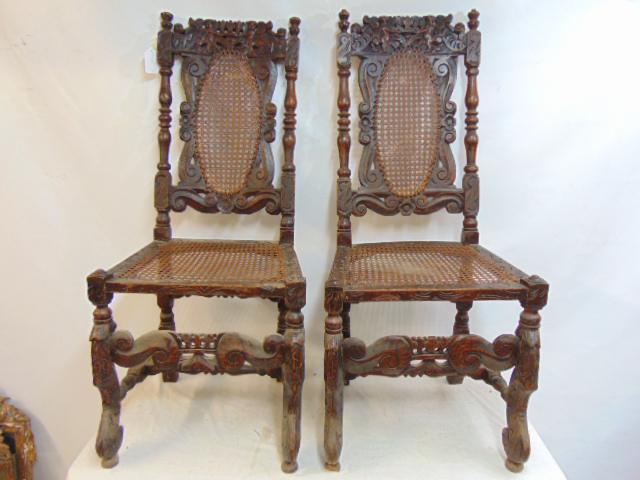 Pair early carved chairs with caned seats & back, carved figures in top, caning is ok.: Pair early carved chairs with caned seats & back, carved figures in top, caning is ok.