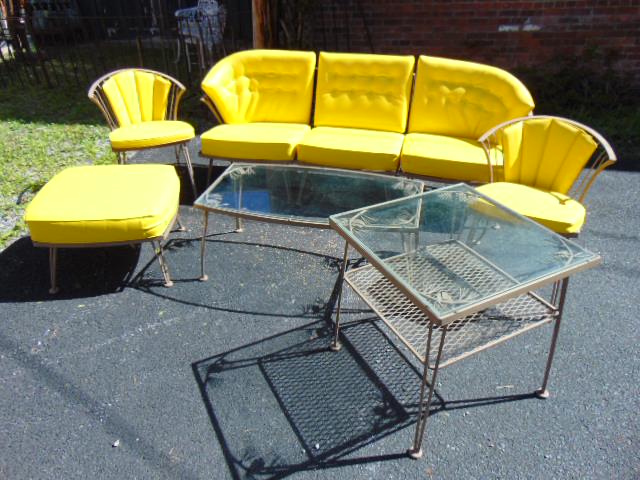 Woodard outdoor iron patio set, 3 part sectional sofa, iron base glass top two tier side & coffee: Woodard outdoor iron patio set, 3 part sectional sofa, iron base glass top two tier side & coffee table with pine cone decorated corners ottoman & pair side chairs, with clean yellow pillows, sofa is