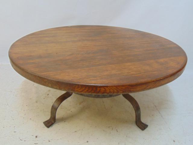 Iron base, oak top round coffee table, ex Robert Altman, top is 29.5" in diameter, height is 16": Iron base, oak top round coffee table, ex Robert Altman, top is 29.5" in diameter, height is 16"