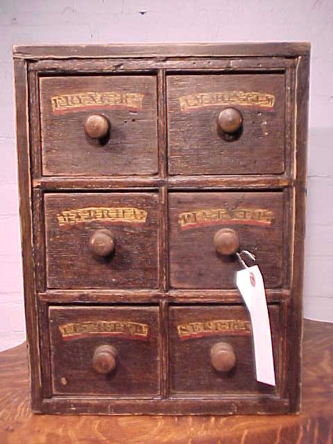 Early English apothecary cabinet 6 drawers: Early English apothecary cabinet with 6 drawers, old labels identify the contents, case is distressed, several cracks on top & sides, see images for detail. 15" tall, 11.25" wide, 10" deep.