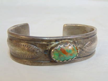 Jewelry. Navajo Native American sterling silver turquoise cuff bracelet w/ oval central stone 77.42: Jewelry. Navajo Native American sterling silver turquoise cuff bracelet w/ oval central stone 77.42 grams; gap opening 1 1/2"; 6 1/4" circumference