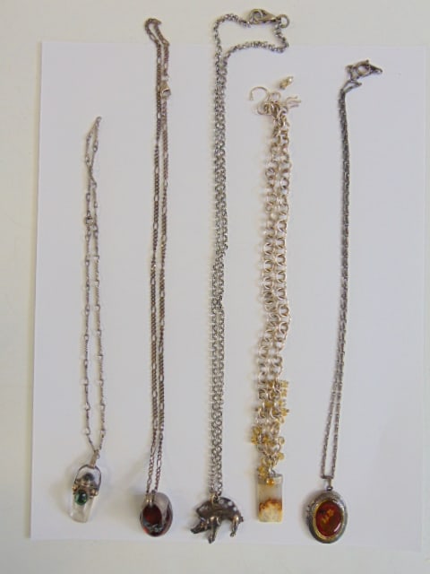 Jewelry. (5) Sterling silver necklaces to include amber shoe pendant, boar pendant, floral locket, &: Jewelry. (5) Sterling silver necklaces to include amber shoe pendant, boar pendant, floral locket, & 2 crystal pendants