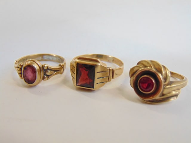 Jewelry. (3) gold rings 14kt & 10kt to include two 14kt yellow gold rings square set stone garnet? (1 of 6)