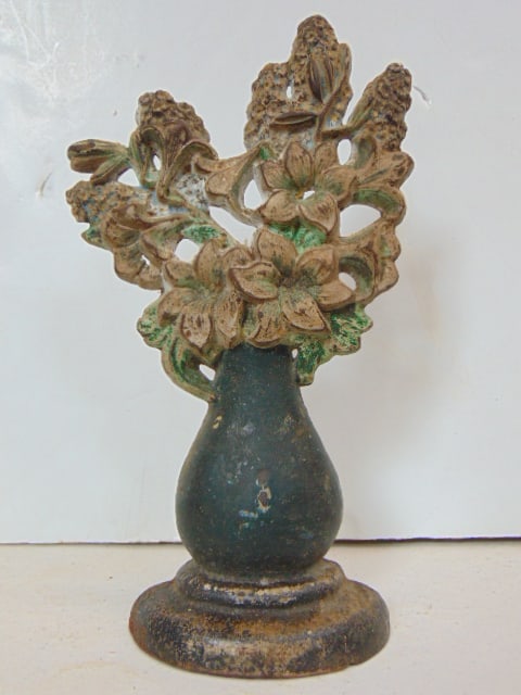 Cast iron doorstop, flowers in vase, 10 3/8" tall.: Cast iron doorstop, flowers in vase, 10 3/8" tall.