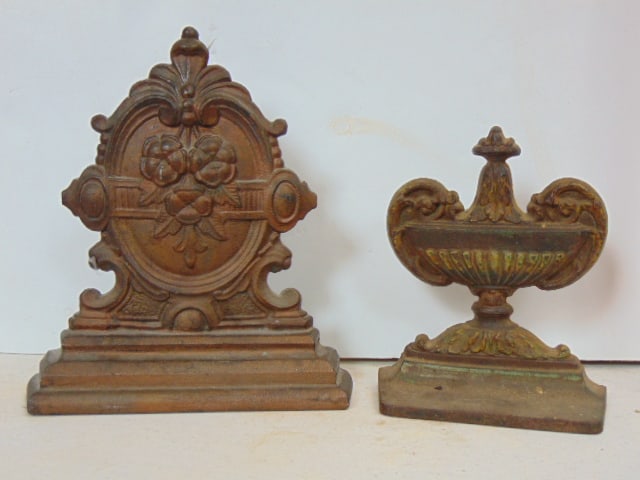 2 cast iron doorstops, finial style, one is numbered 60 & signed illegibly, other is marked 5L, (1 of 5)