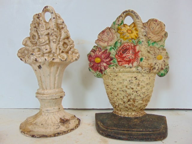 2 cast iron floral doorstops, one with small paper label, Hubley, 8.5" & 8.76" tall (1 of 4)