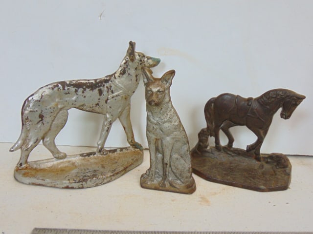 3 cast iron doorstops, horse & 2 German shepherds, one walking, one seated, horse is marked, 1930, (1 of 5)
