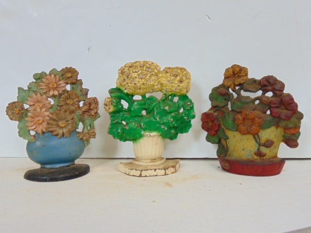 3 cast iron doorstops, Hubley #488, Primrose Flowers, 7 3/8"; Hubley 232, Daisy Bowl, 7" & unmarked (1 of 5)