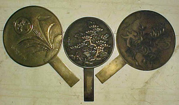 Lot 3 Japanese Bronze mirrors: Lot 3 Japanese Bronze mirrors. 9 1/2"; 10 1/2"; 11" long. All three in good condition and still giving reflections, although plenty of scratching and wear to "mirror" surface.
