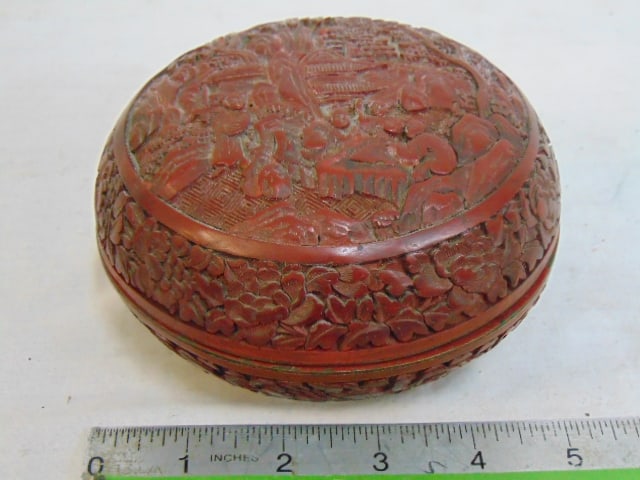 Carved Cinnabar box with lid, fine carved detail with various figures, temple, trees, has damage on (1 of 6)
