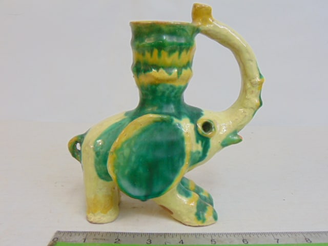 Ceramic elephant, possibly Walter Bosse, Wiener werkstatte style, signed illegibly, in green, yellow: Ceramic elephant, possibly Walter Bosse, Wiener werkstatte style, signed illegibly, in green, yellow glazed terra cotta, 7.5" tall, few small chips around ear, tusk, and bottom feet