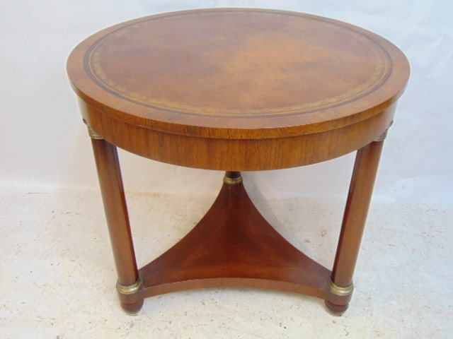Round leather top center table by Kittinger, triple column base with silver-plated (?) collars, (1 of 8)