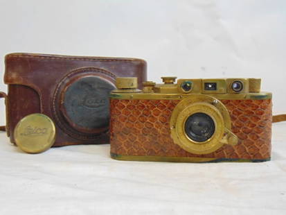 Vintage Leica camera, in brass with snake skin covered body, Russian copy: Vintage Leica camera, Russian copy, in brass with snake skin covered body, serial number 109724, comes with original leather case. Please note that several bidders pointed out this is a Russian reprod