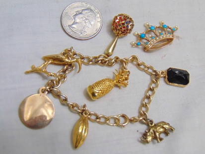 Gold Filled charm bracelet w/ Gold & Gold filled charms & gold pin: bracelet chain is gold filled; 14k Aztec round charm; 14k Italy ball charm; 10k charm looks like a long football; Scorpio charm 14k; Rhino charm is not gold; crane is not gold; pineapple is not gold;