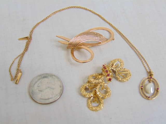 Jewelry. Gold lot to include 14kt gold bow pin/brooch w/ 5 small red gem stones each set in 4 prong (1 of 5)