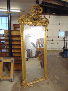 Large 19th century fire gilt pier mirror with carved top, some loss of flowers along top, height is: Large 19th century fire gilt pier mirror with carved top, some loss of flowers along top, height is 91", width at top is 39"