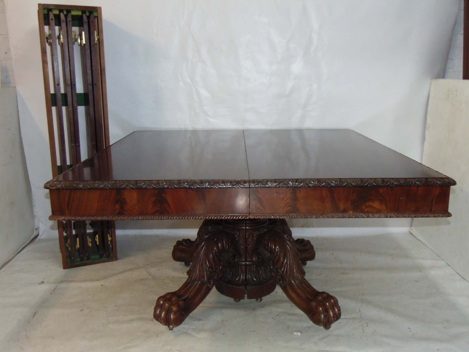 Mahogany dining table with cornucopia carved base, claw feet, fine quality square dining table with: Mahogany dining table with cornucopia carved base, claw feet, fine quality square dining table with carved edge, comes with rack of 5 leaves, table is 54" by 53.5", wide skirt, carved edge on skirt as