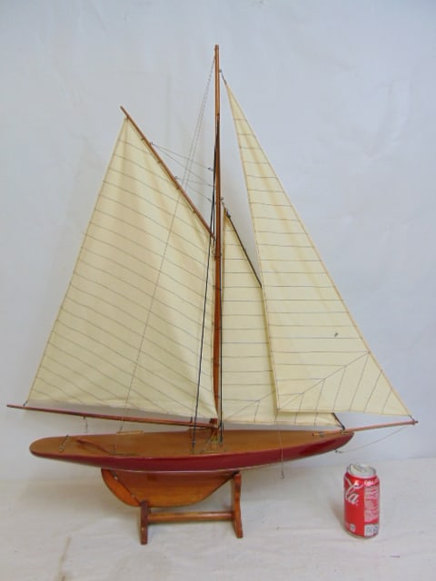 Sailboat model, natural wood hull with red band, full sails, hull is 25", height is 37" as shown, on: Sailboat model, natural wood hull with red band, full sails, hull is 25", height is 37" as shown, on stand
