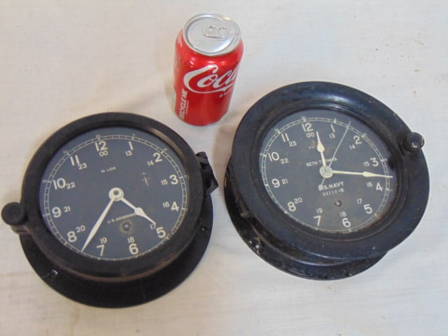 2 US Navy ship's clocks, M.Low, US Government & U.S. Navy, Seth Thomas, black cases, Seth Thomas is: 2 US Navy ship's clocks, M.Low, US Government & U.S. Navy, Seth Thomas, black cases, Seth Thomas is 7 5/8" in diameter, M. Low is 6.5", M. Low clock missing part of mounting ring, as is