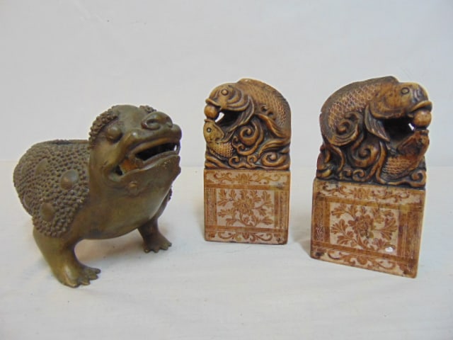 Chinese bronze foo dog vessel on 3 legs & pair carved soapstone Chinese seals with fish carvings,: Chinese bronze foo dog vessel on 3 legs & pair carved soapstone Chinese seals with fish carvings, bronze vessel (incense ?) is missing lid or cover on back.
