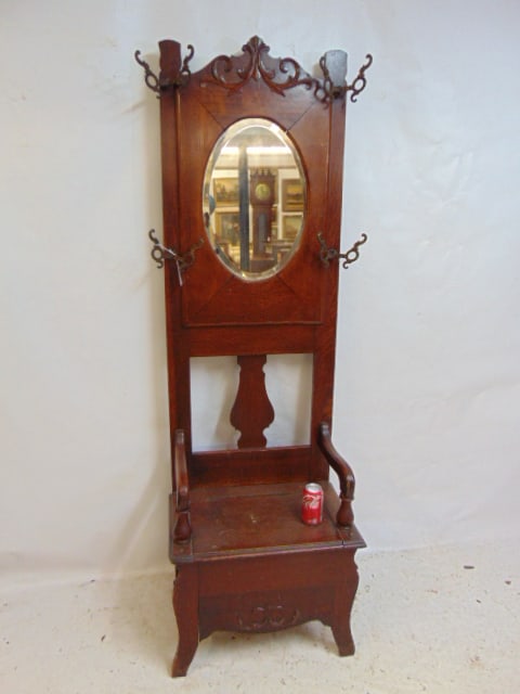 Oak hall tree, lift seat, oval beveled glass mirror, height is 75": Oak hall tree, lift seat, oval beveled glass mirror, height is 75"