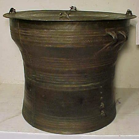 Shan Hill Tribe Bronze Drum: Estate of Louise R. Smith. From third party appraisal: "Shan Hill Tribe bronze drum of circular form on a tapering foot, cast on the top with four groups of mythical beasts around a circular star-shap