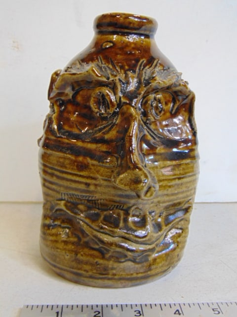 Face jug by W.T. McLennan, Hollytree, Ala. smiling face with big nose, 7.5" tall, chip on right ear, (1 of 6)