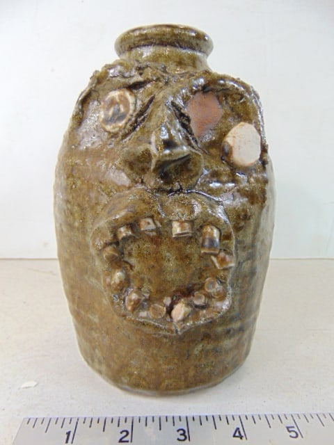 Face jug by M.T. McLennan, Hollytree, Ala. ,left eye sagging (unsure if firing mistake or (1 of 6)