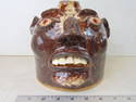 Face jug by Frank Edward van Dorsten, in beige brown with red eyes, height is 7", in good condition.