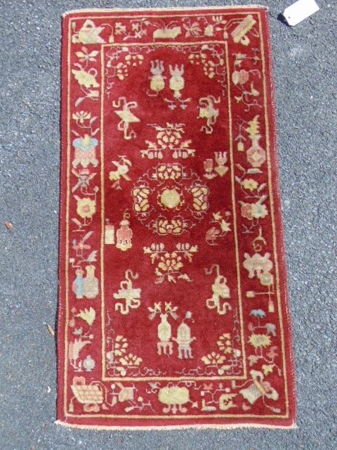 Small Chinese scatter rug, in red with various decorative designs, 46" by 24" (1 of 4)